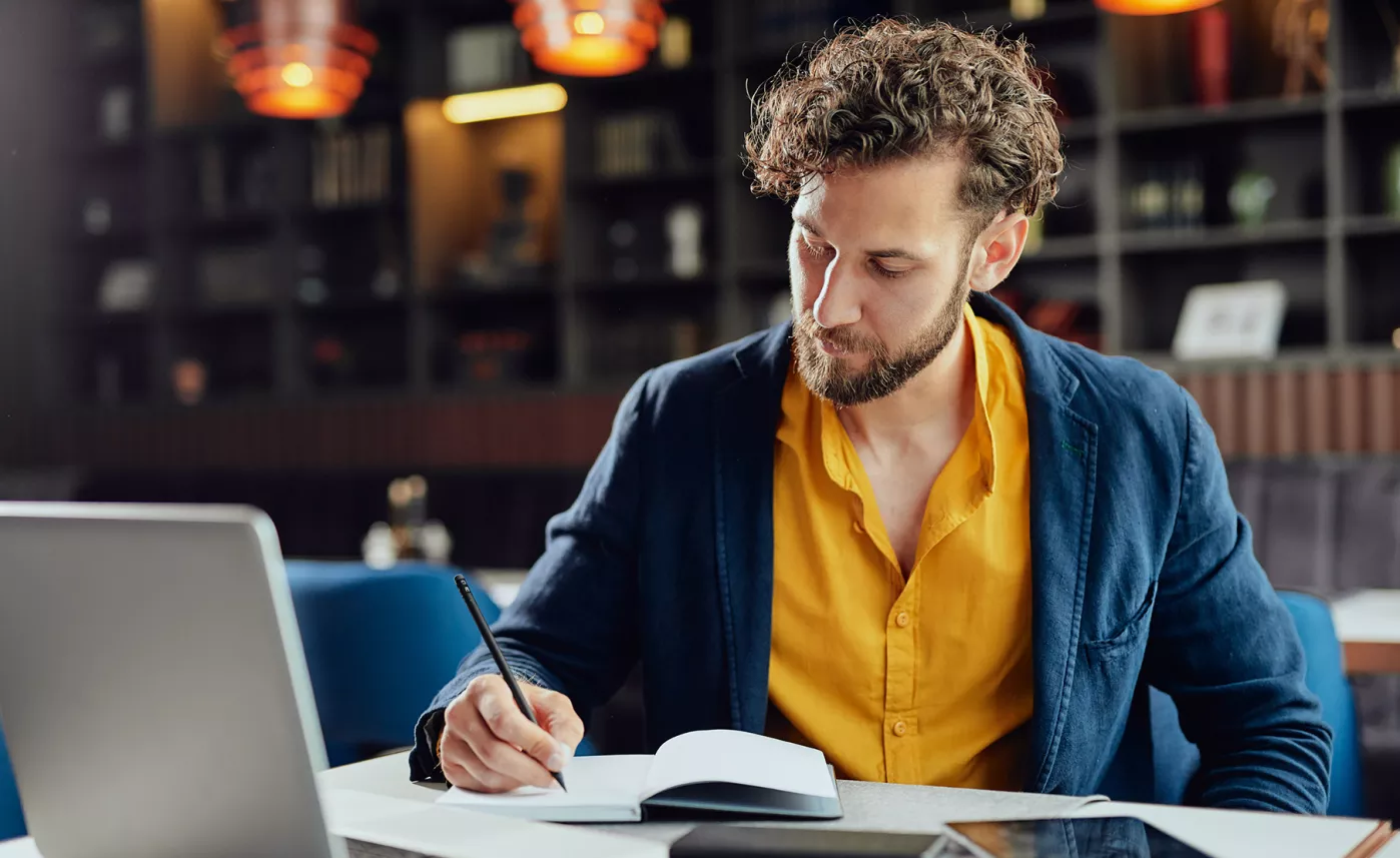  Man writing at desk
