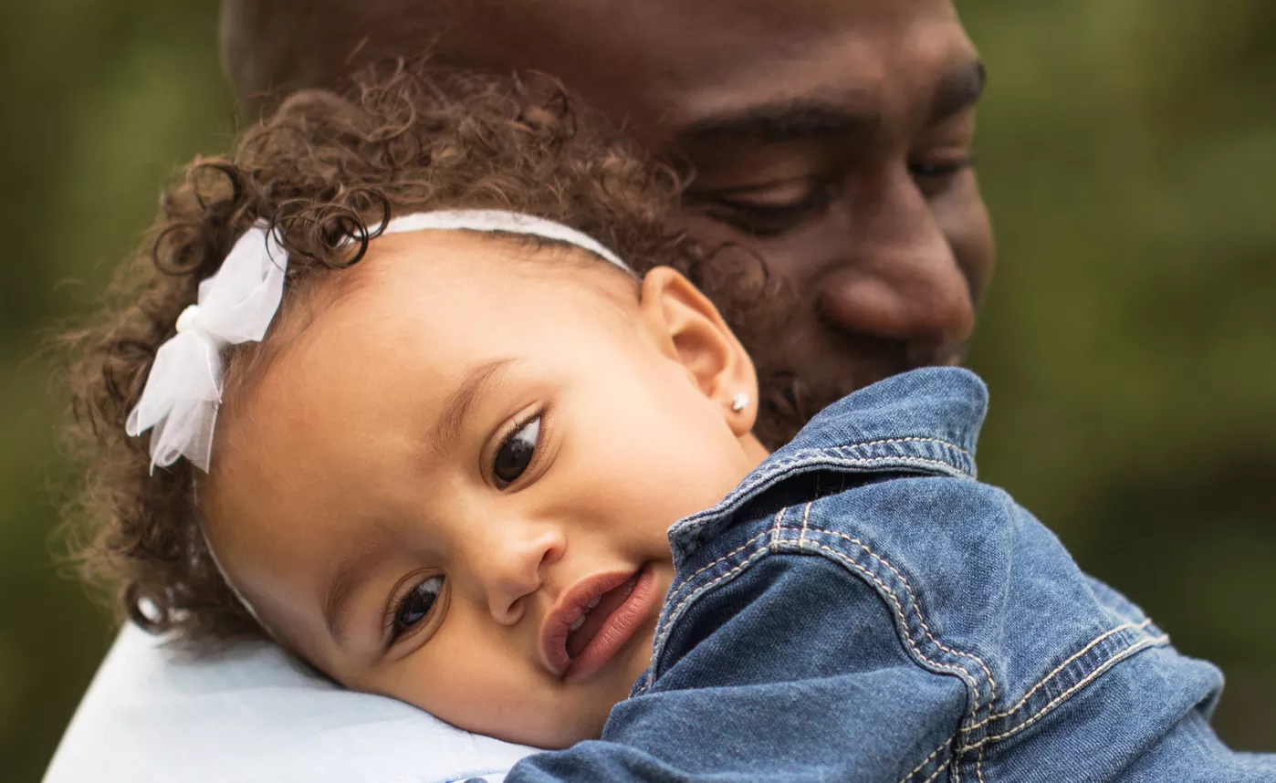  A new grandparent holds his infant granddaughter.
