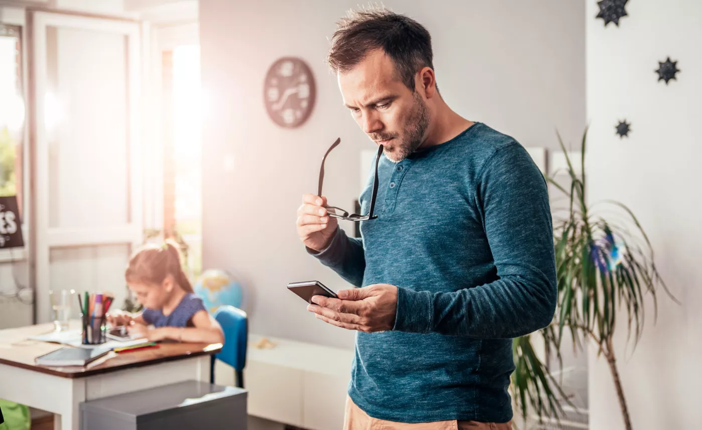  Father looking at mobile device
