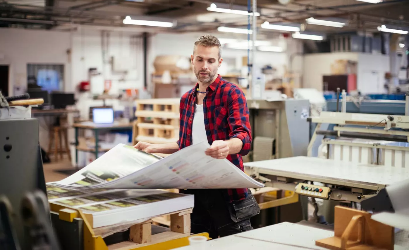  Man viewing large graphic document
