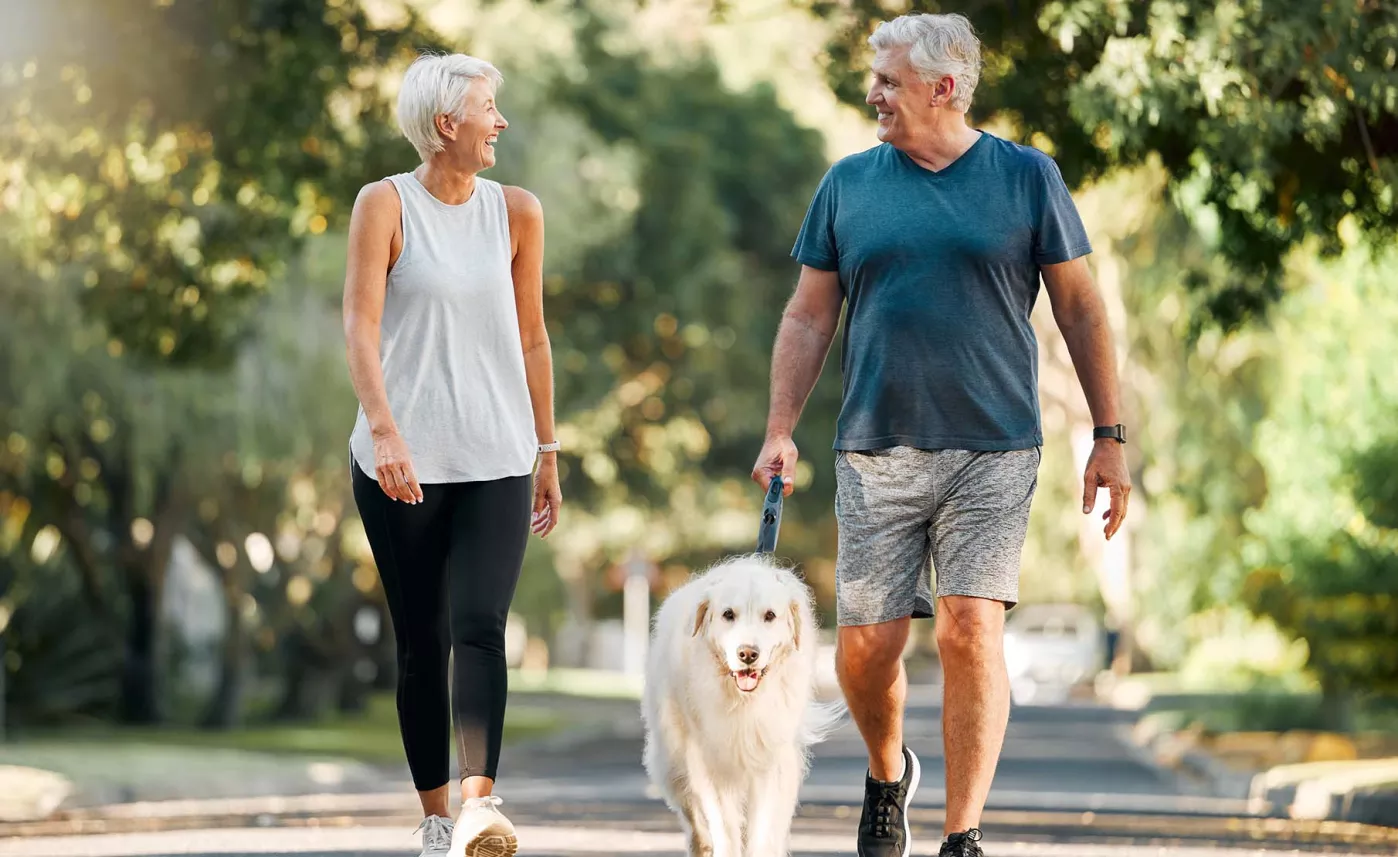 couple walking with their dog

