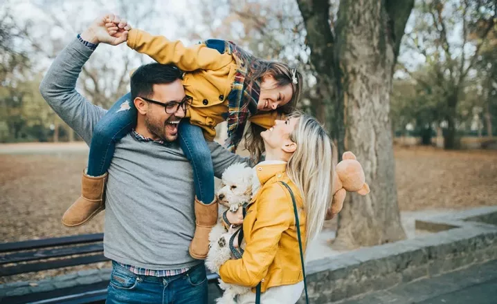  Family with dog walking in park
