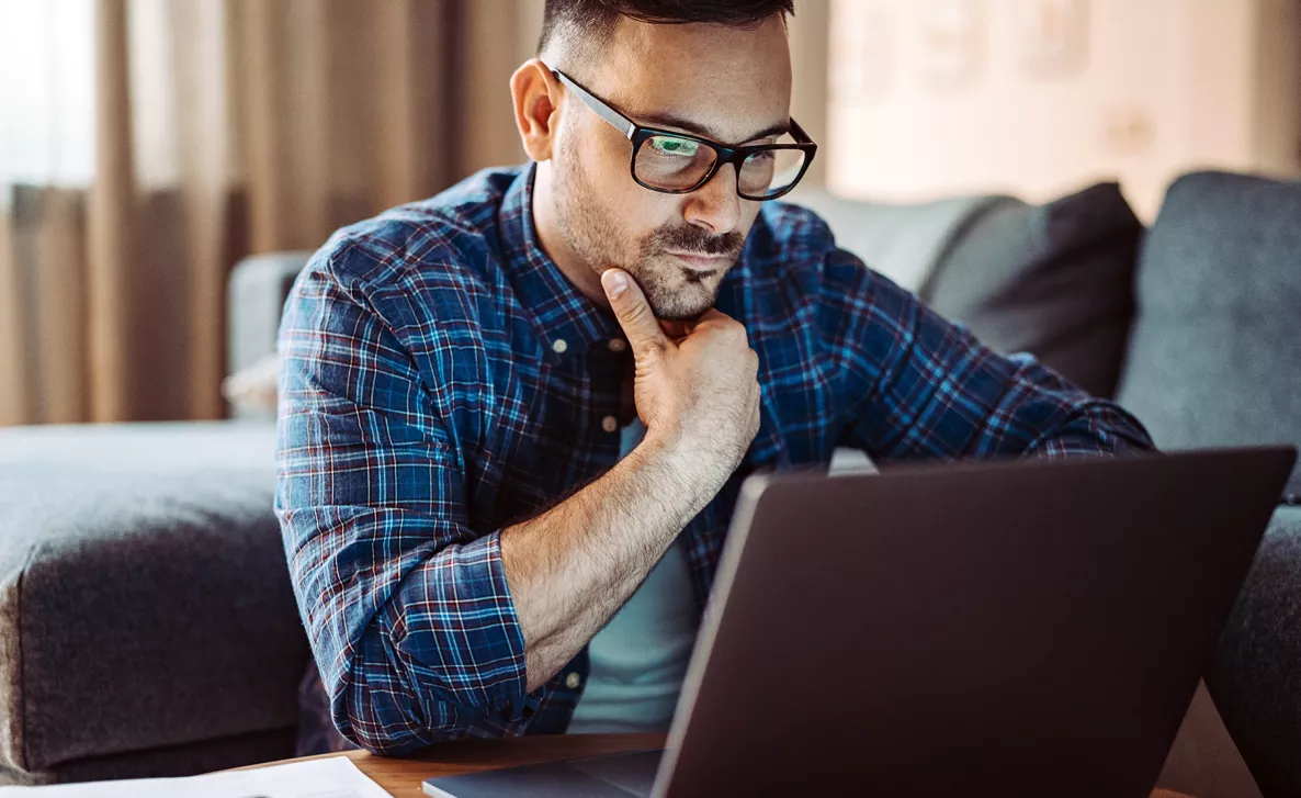  A man looking at his laptop
