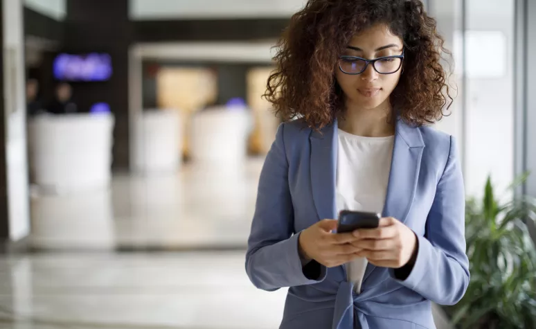 An Edward Jones client is creating a text message on her mobile phone. 