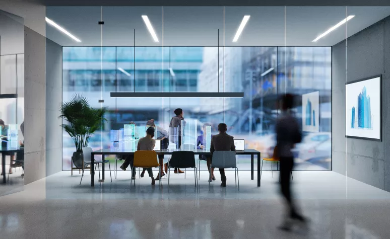 Employees talk together in a conference room of a modern office building.