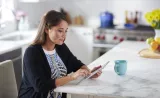 An Edward Jones client reviews financial documents on her tablet.