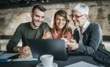 A couple reviewing their investments with a financial advisor.