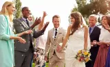 A newly married couple celebrate with their friends and family at their wedding.