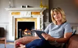 Woman sitting on sofa looking at options to give