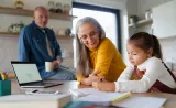 An Old couple teaching their grand daughter