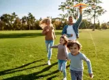 Adult walking with toddler outdoors