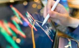 Stock market charts on an electronic screen.